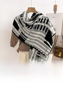 Detail of soft black and white geometric wool-like scarf with houndstooth patterns