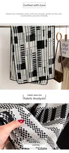 Detail of soft synthetic wool scarf showing modern geometric patterns and smooth fabric texture