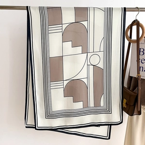 Detail of geometric pattern scarf with neutral beige and grey artistic color blocks