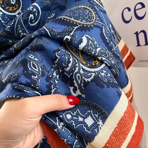 Close-up of retro navy paisley shawl showing dense woven fabric and striped edge