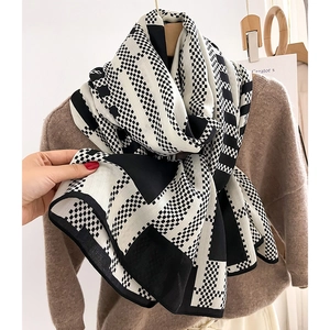 Modern black and white geometric pattern scarf with checkerboard and striped knit design