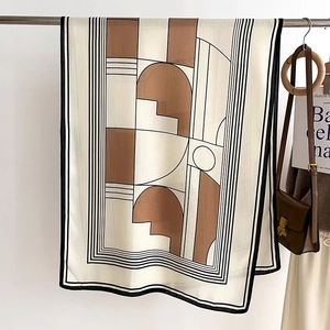 Detail of elegant striped scarf with geometric patterns in caramel and ivory colors