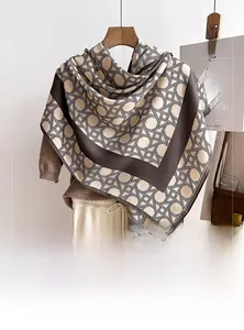 Detail showing the geometric plaid pattern and soft wool-like texture of the winter scarf