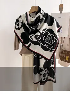 Detailed close-up of camellia pattern scarf in premium faux wool black and white style