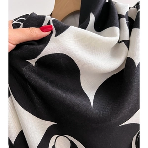 Classic camellia print scarf with black and white patterns and soft draped texture