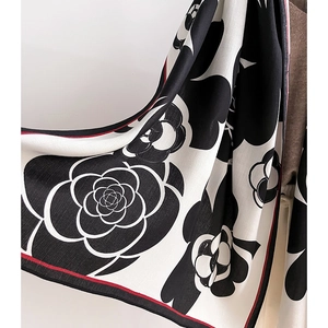 Detail of camellia flower print on twill scarf with contrast red piping edge
