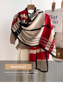 Detail of soft red and black striped shawl made of high-quality faux sheep wool fabric