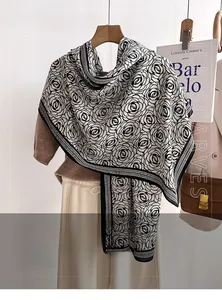 Detail of soft imitation wool scarf featuring elegant black and white rose patterns