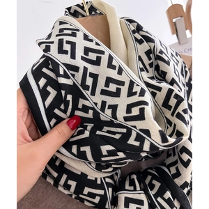 Warm winter scarf with black and white geometric pattern in thick knit texture