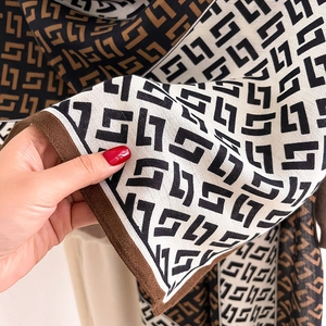 Close-up of tricolor geometric scarf showing fine twill weave and soft texture detail
