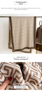Detail of soft imitation wool scarf featuring brown and beige Greek key geometric patterns