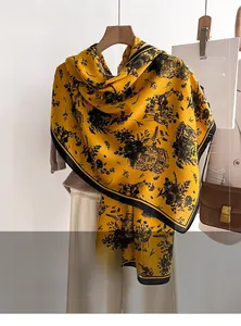 Detail of yellow wool-like scarf showing vintage French architecture and floral prints