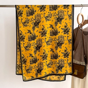 Detail of yellow Toile de Jouy shawl with black castle pattern and contrast piping