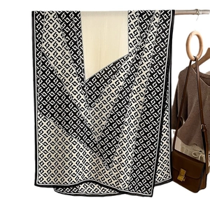 Classic black and white geometric pattern shawl scarf for women in a stylish outfit context
