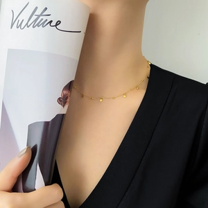 Chic 18k gold plated necklace with small round pendants worn by a fashion model