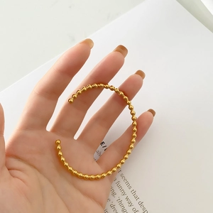 Minimalist rose gold beaded cuff bracelet for women featuring polished round metallic beads