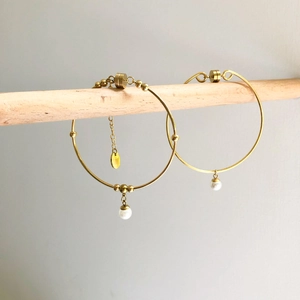 Minimalist gold hoop earrings with metallic beads and elegant white pearl pendants