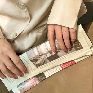 Close-up of minimalist gold hammered rings worn on fingers with a vintage French aesthetic