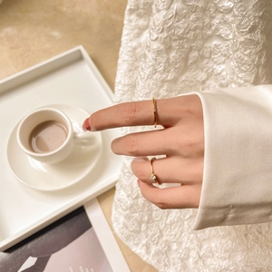 Close-up of minimalist 18K gold plated titanium rings with sparkling cubic zirconia stones
