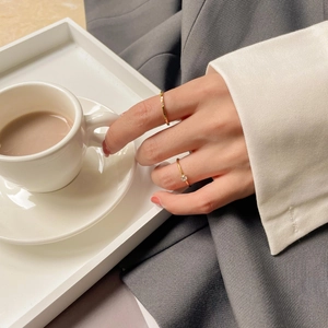 Detail of 18K gold plated titanium rings with sparkling zircon on a woman's hand