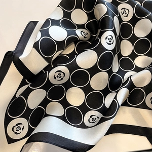 Elegant silk scarf with classic black and white polka dots and camellia flower patterns