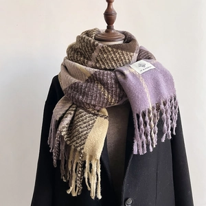 Detail of soft plaid scarf with tassels in purple and brown thick cashmere-like knit