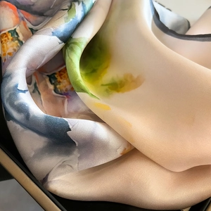 Artistic watercolor mulberry silk square scarf with vibrant floral pattern and satin finish