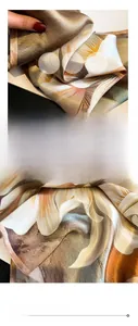 Detailed view of 100% mulberry silk scarf featuring floral print and hand-rolled edges