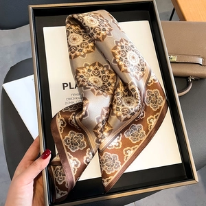 Elegant mulberry silk scarf with vintage mandala pattern displayed on a tray