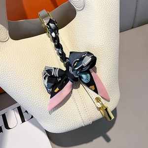 White pebbled leather bucket bag with printed silk scarf handle and gold padlock charm