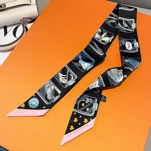 Silk twilly scarf with animal prints on an orange gift box and white leather bag
