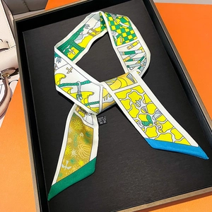Detail of multi-color printed silk twilly scarf with abstract patterns on black display tray