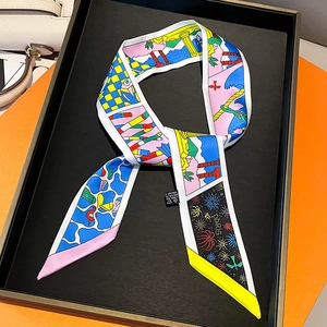 Detail of printed silk-like handbag scarf featuring Paris graphics on a display tray