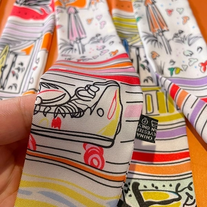 Polyester twilly scarf with colorful beach umbrella print on bright orange background
