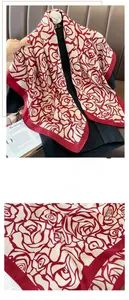 Detailed close-up showing the fine hemming and floral damask pattern on the silk scarf