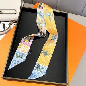 Close-up of a 100% polyester orange twilly scarf featuring horse and geometric patterns