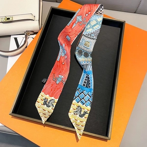Detail of multi-color printed silk twilly scarf with horse patterns on a display tray