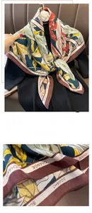 Detailed view of precision stitched edges on vintage floral scarf with CHANGE pattern