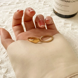 Minimalist gold heart ring set including a polished signet and hollowed heart band