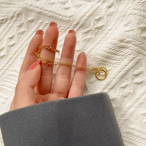 Minimalist double circle golden chain bracelet with smooth and twisted rings texture