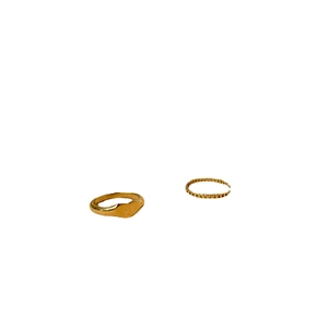 Minimalist gold heart signet ring and hollow band set for women on white background