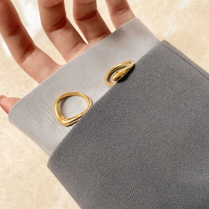 Detail of 15k gold plated geometric open rings with minimalist abstract snake design