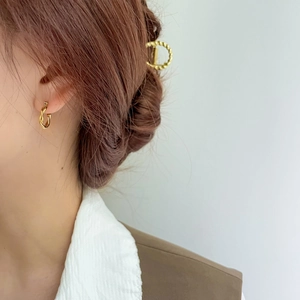 Minimalist golden twist hoop earrings with a high-shine finish for women's jewelry