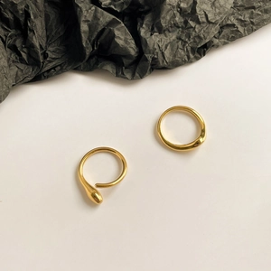 Close-up of minimalist 15k gold plated geometric snake ring on white background