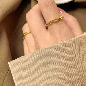 Chic gold-plated woven chain ring and textured band set worn with elegant clothing