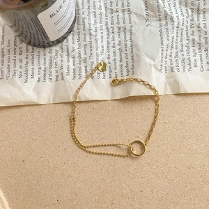 Bracelet double couche en or minimaliste avec breloque circulaire et fermoir mousqueton chic