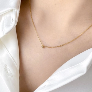Elegant gold choker necklace for women with a tiny sparkling solitaire zircon pendant