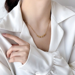 Elegant gold bead necklace for women on neck, minimalist dainty chain jewelry style