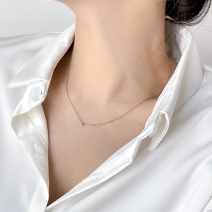 Elegant gold choker necklace featuring a single round zircon pendant on thin dainty chain