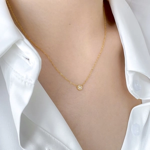 Minimalist 18K gold plated necklace with a sparkling round cubic zirconia pendant on model